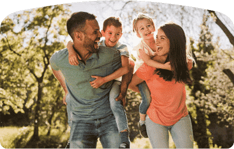 couple with their two children on their back smiling